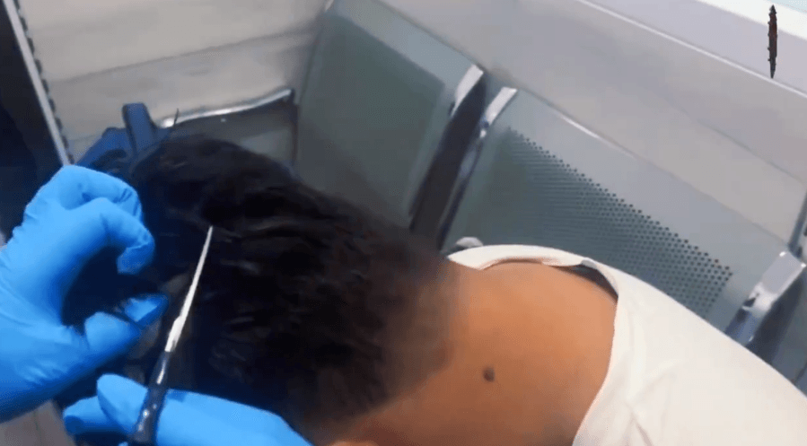 WATCH: Officers cut open man's ‘narco wig' at Colombian airport to reveal cocaine