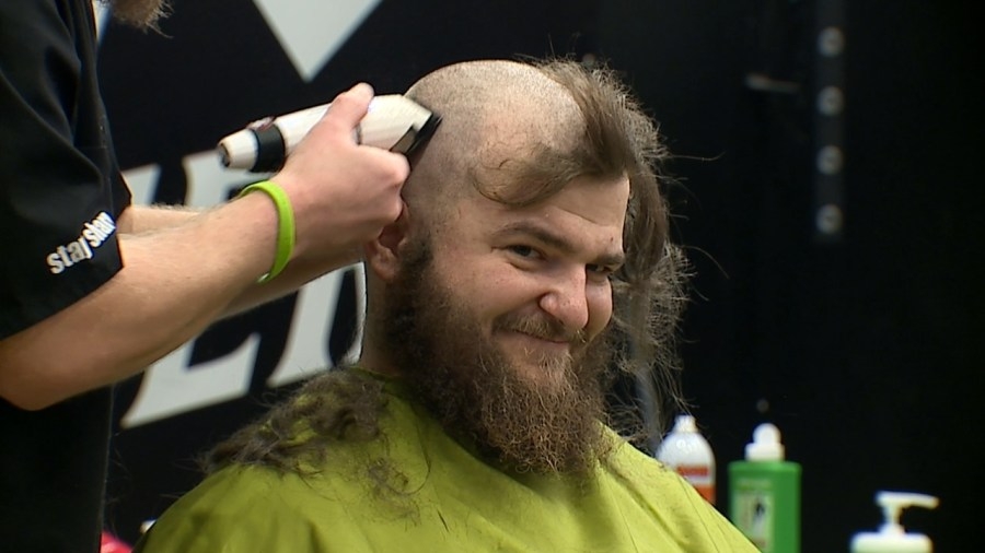Volunteers shave heads to raise money for childhood cancer research