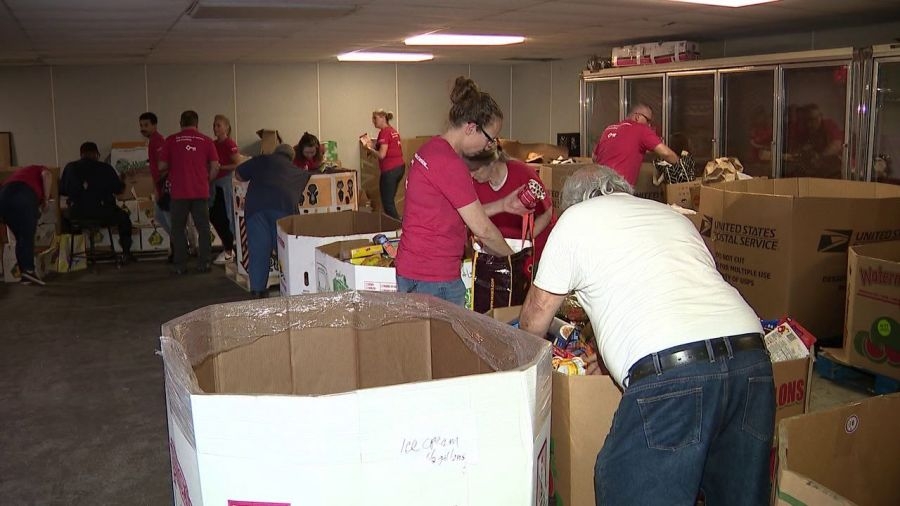 Bank volunteers sort food at community center