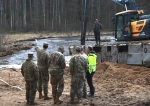 US armored vehicle pulled from swamp but fate of 4 soldiers still unknown