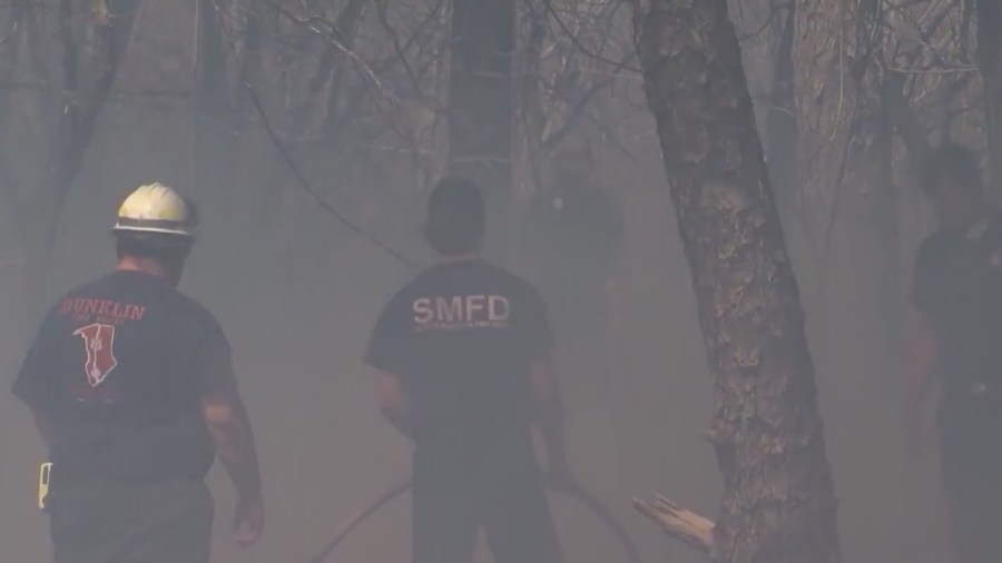 Firefighters gather in prayer as they continue to battle Upstate Wildfire