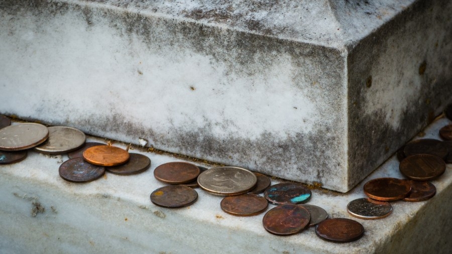 Honoring heroes: The significance of coins on their graves