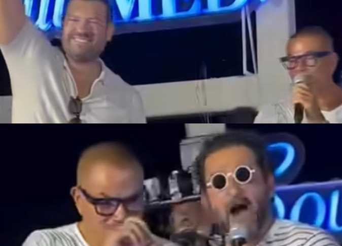 أحمد حلمي وعمرو يوسف يفاجئان عمرو دياب على المسرح خلال حفله بالساحل الشمالي (فيديو)