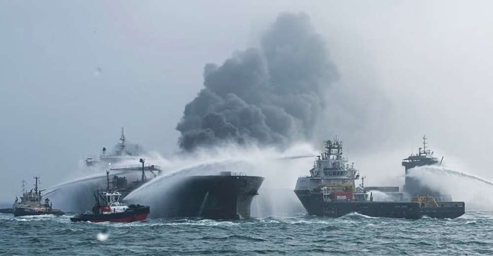 Tanker hired by US military ablaze after hit by container ship