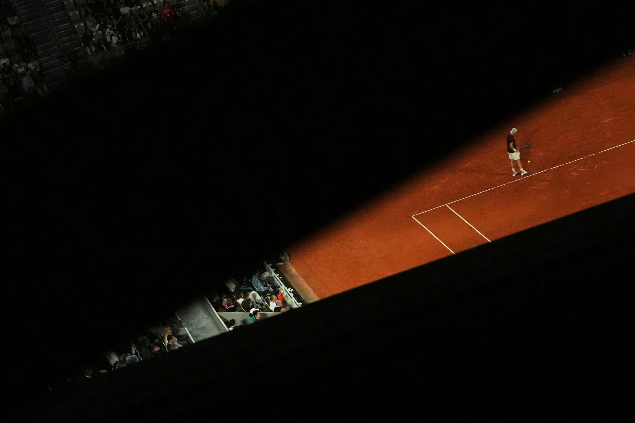 AP PHOTOS: Light and shadows add an extra dimension at the French Open tennis tournament