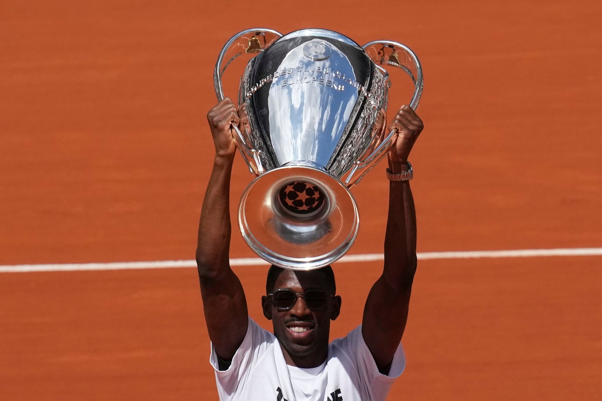 PSG star Dembélé raises Champions League trophy at the French Open