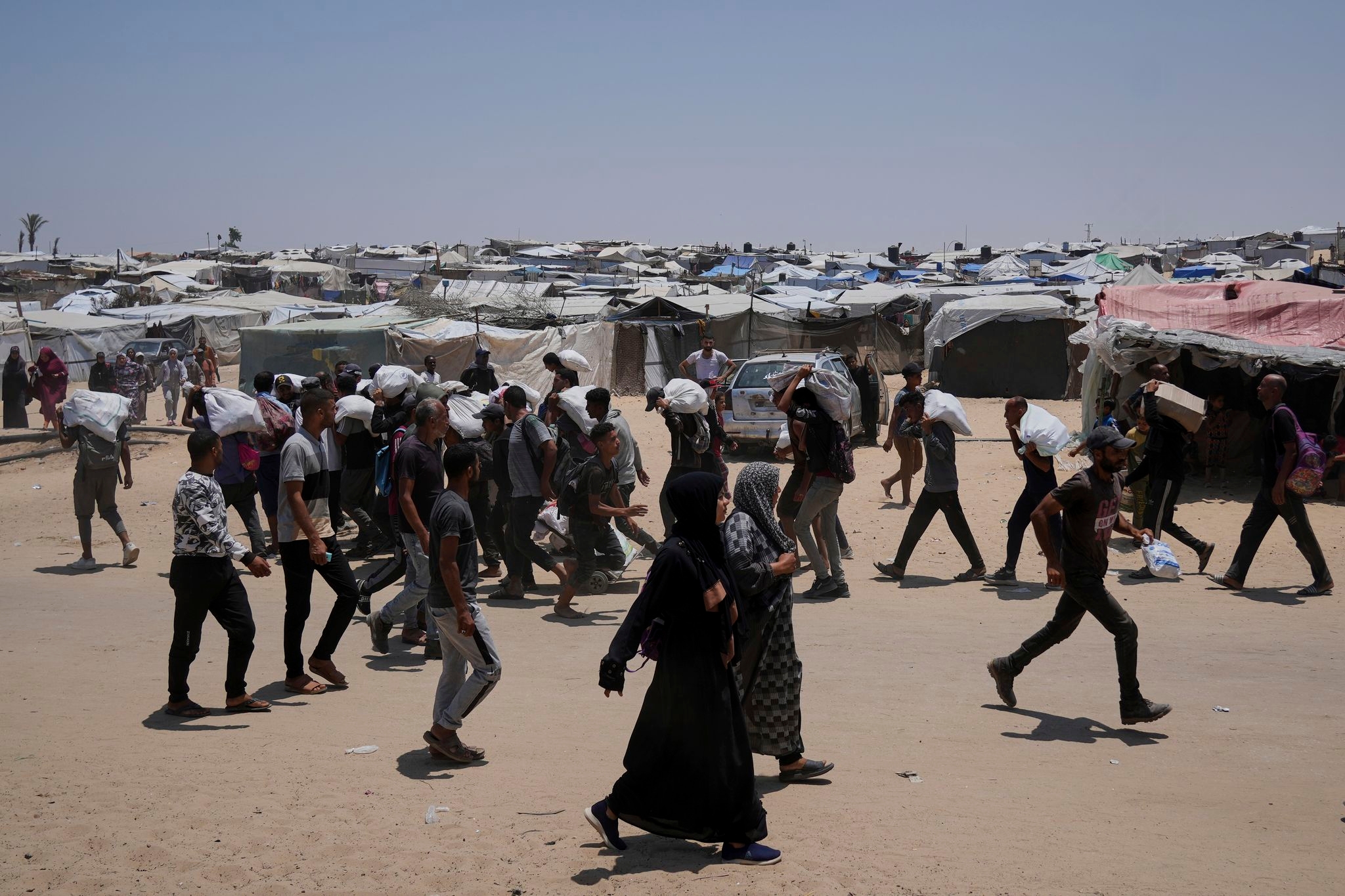 Palestinians say Israeli fire kills 5 near aid sites. Israel says it fired warning shots