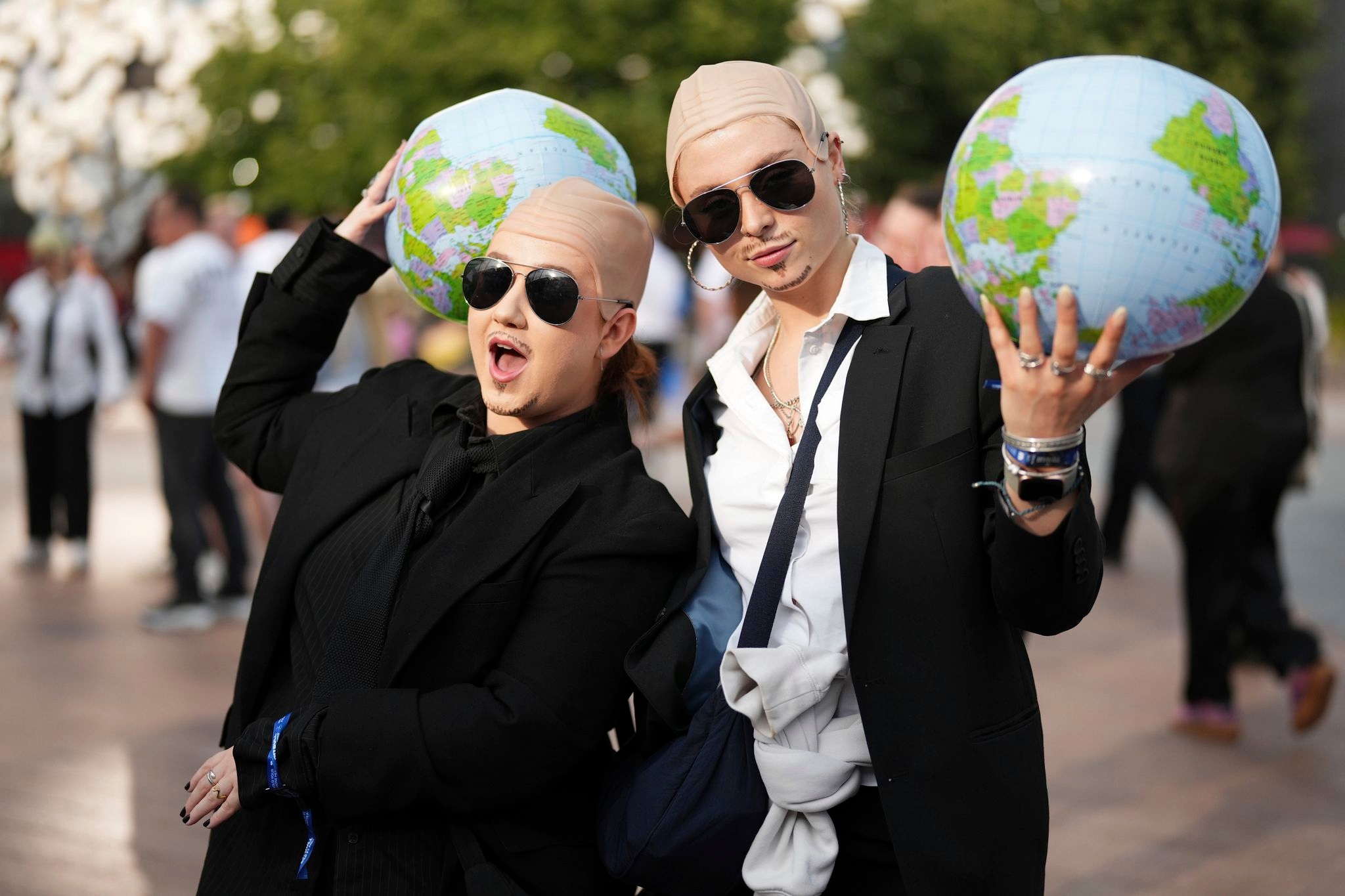 White shirts. Black ties. Bald caps. Pitbull's fans party like clones worldwide