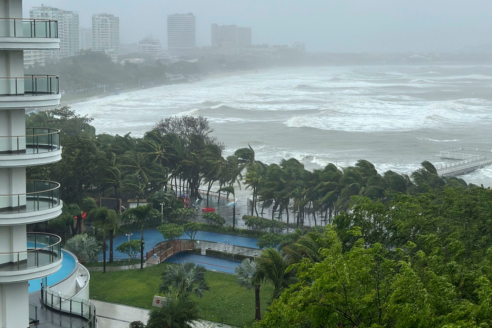 A severe tropical storm heads for southern China after toppling trees on Hainan island