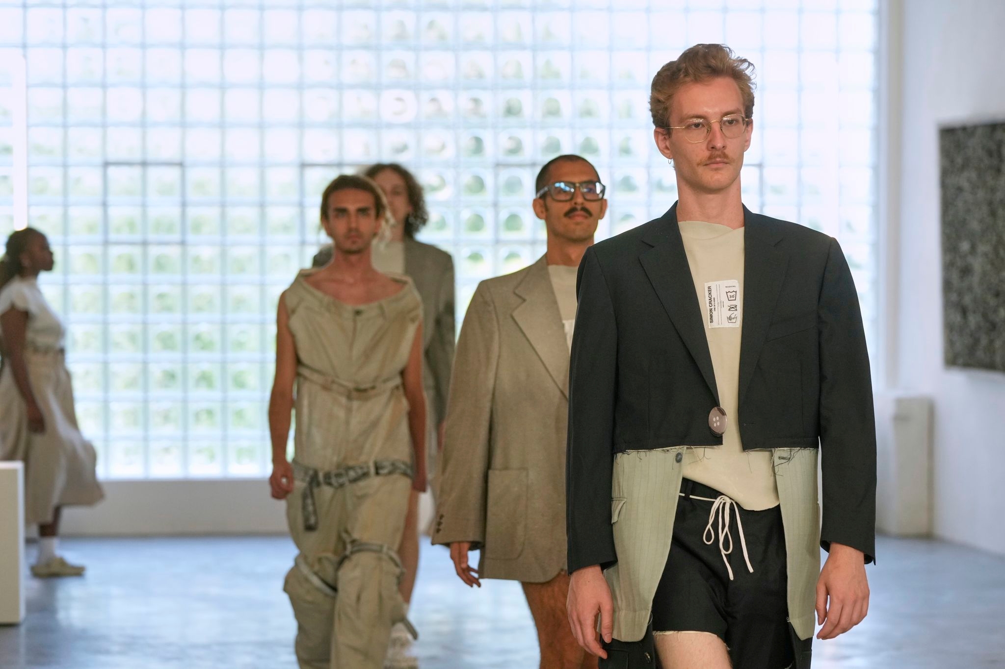 Simon Cracker creates a brand uniform to highlight star upcycled garments during Milan Fashion Week