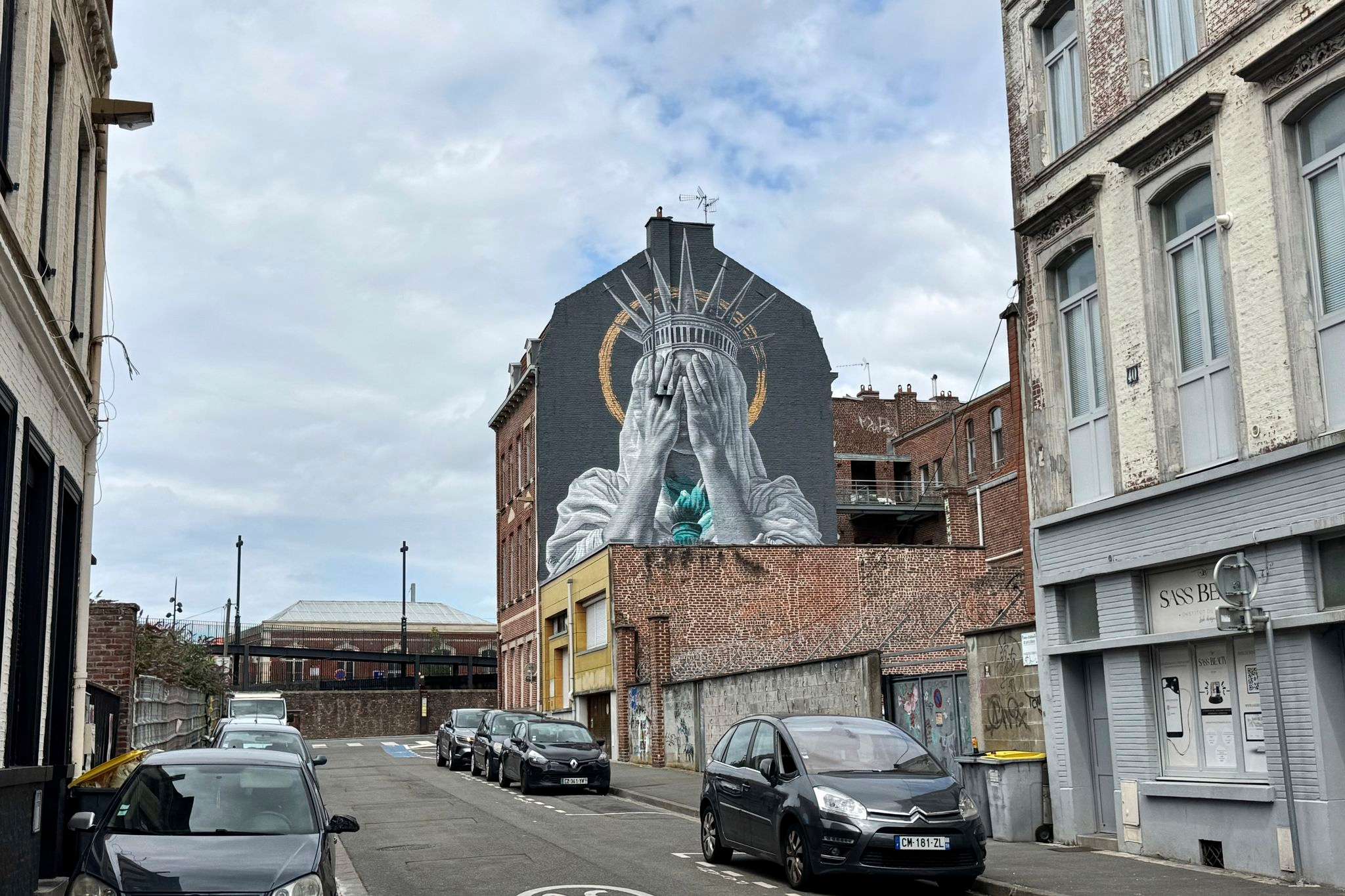 A new mural in France shows the Statue of Liberty covering her eyes in a swipe at Trump