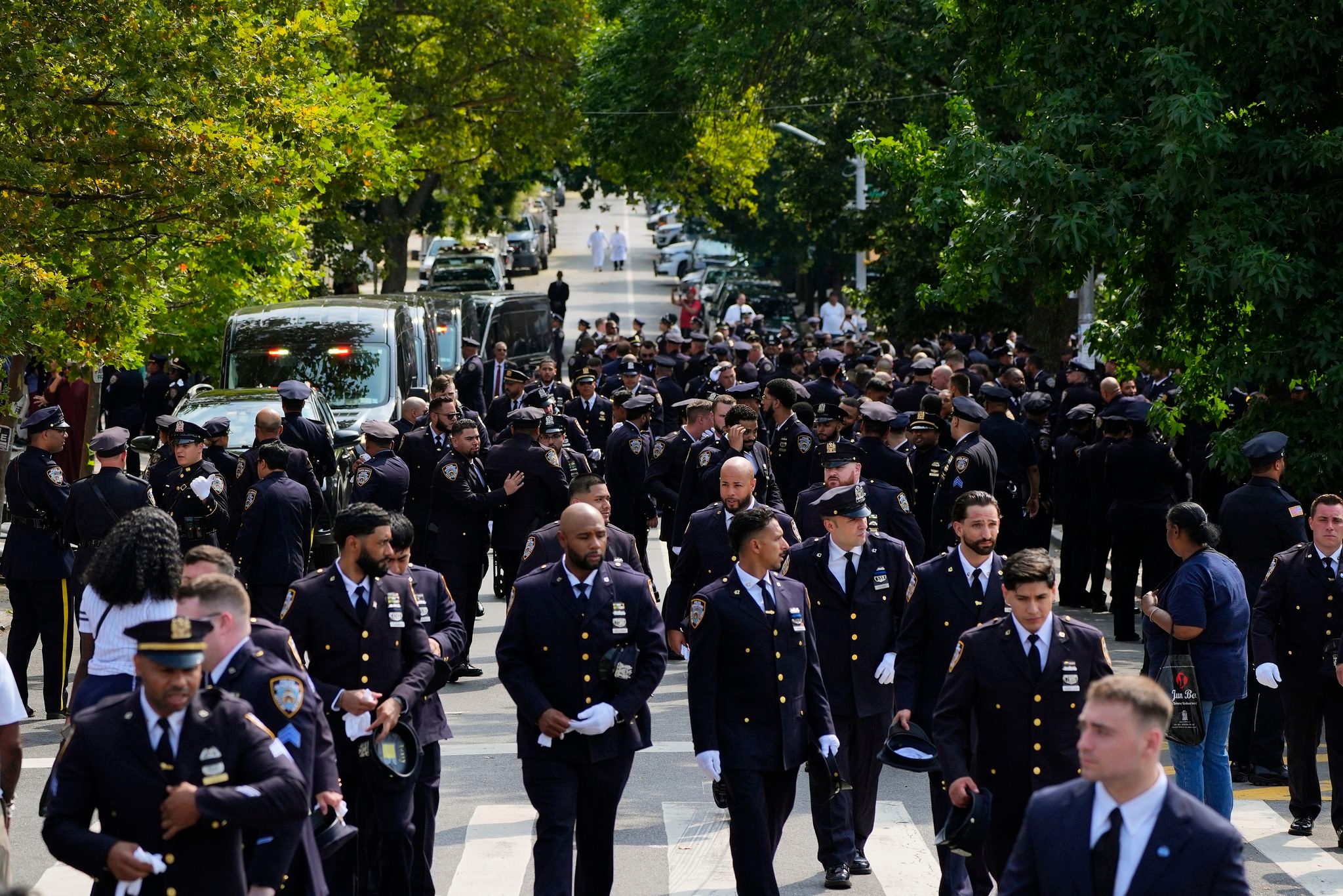 Throngs of police pay tribute to officer killed in New York office shooting