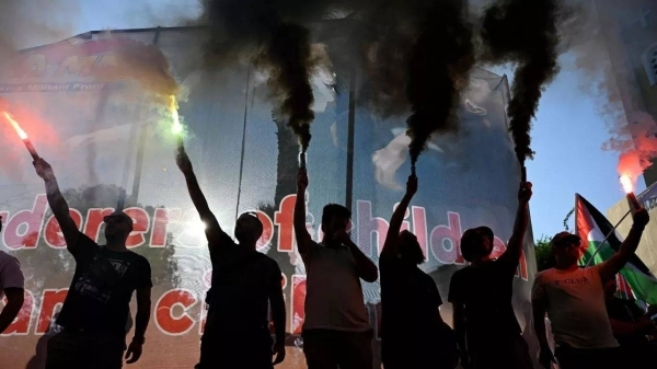 Riot police block pro-Palestine protesters from approaching Israeli cruise ship in Greece