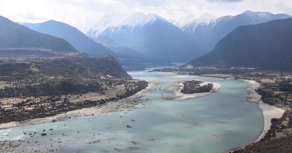What explains India's muted response as China starts work on massive dam?