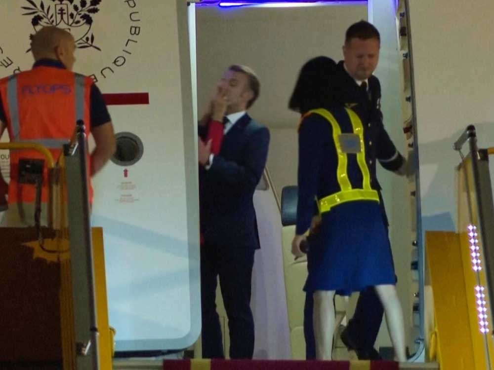 Macron says he and wife were horsing around when she appears to push him