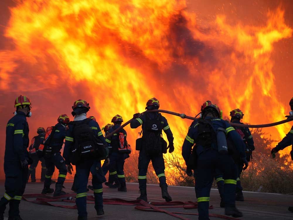 Wildfire prompts evacuations near Athens as summer's first heat wave hits Greece