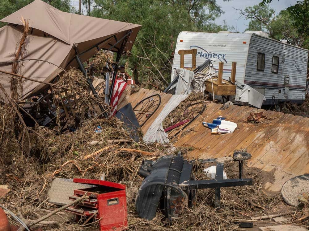 Searchers in helicopters and on horseback comb Texas flood debris for missing people