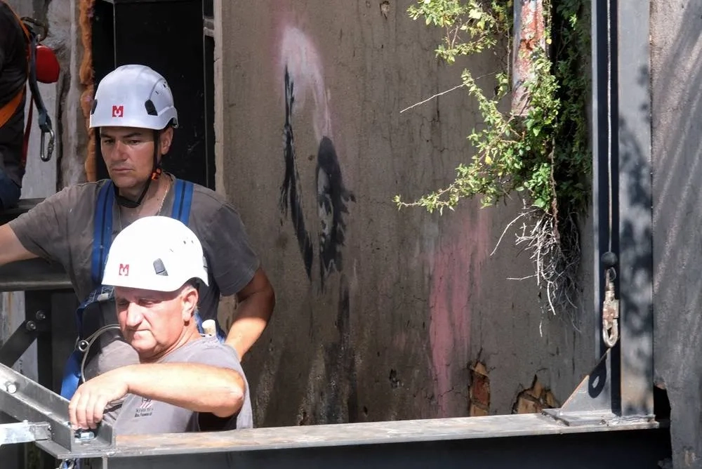 Scaffolding Goes up in Venice to Save Banksy's Migrant Mural