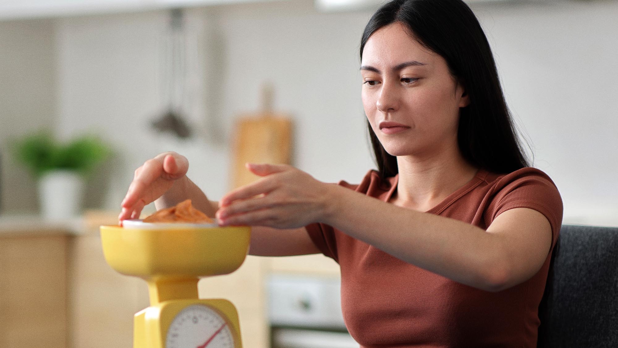 Woman On Diet Weighing Out Peanut Butter Like It Hard Drugs