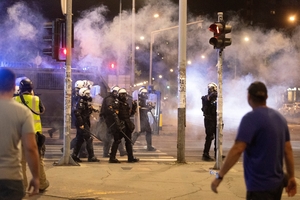 Tensions soar in Serbia as angry protesters clash with police, set fire to party offices