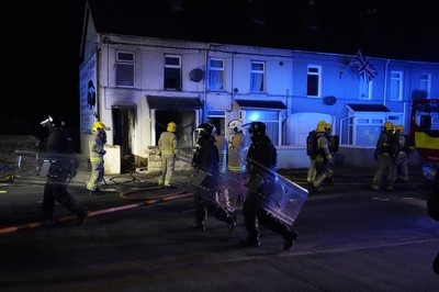 Police use water cannon in response to anti-immigrant violence in Northern Ireland town