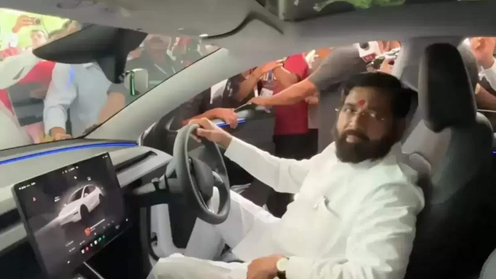 Tesla test drive: Maharashtra Deputy CM Eknath Shinde gets behind the wheel of EV outside state assembly