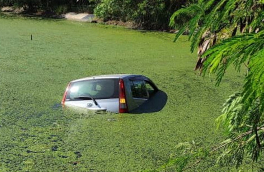 Up to their necks in stink: Mum, son rescued after car plunges into sewage pond in Kota Kinabalu