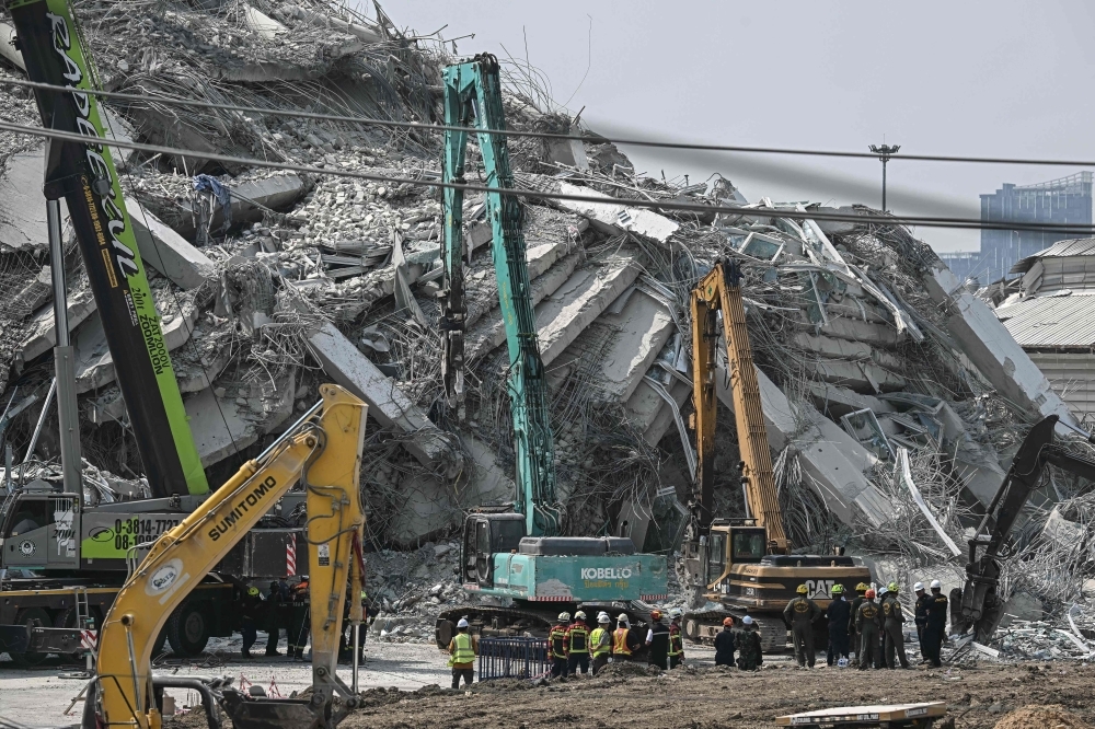 Thai construction tycoon and 14 others surrender to police over fatal Bangkok tower collapse