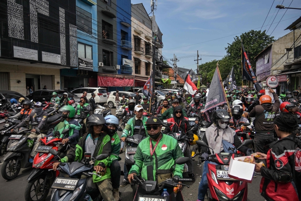 ‘It's about lives': Thousands rally across Indonesia as e-hailing, food delivery riders demand 10pc cap on GoJek and Grab fees