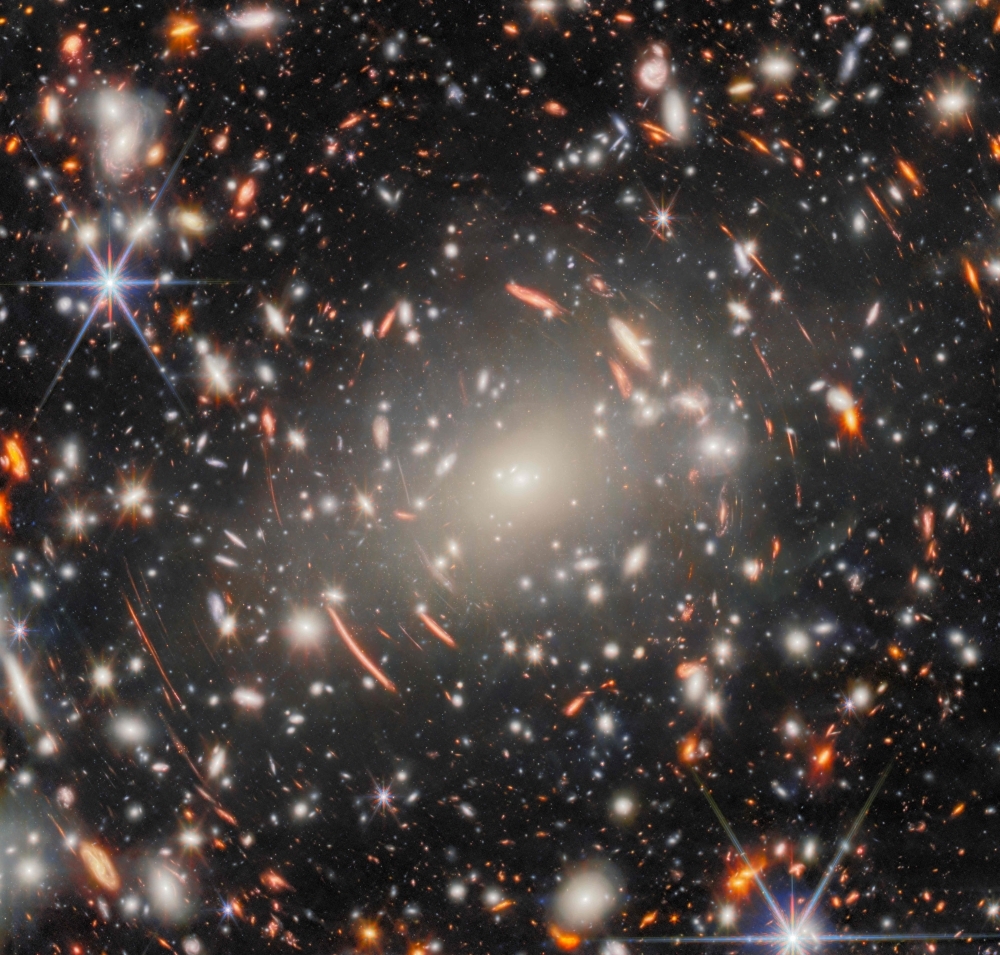 Webb telescope stares deeper into space than ever, revealing warped light from galaxies born near the dawn of time