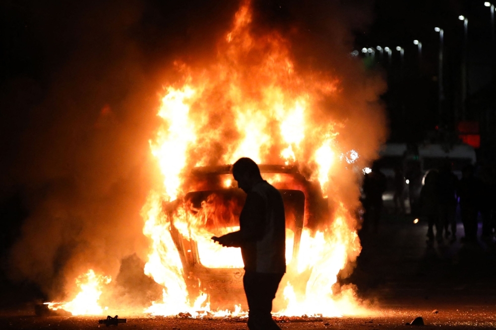Petrol bombs, fires and fear as racial tensions explode in Northern Ireland town following teen rape charges