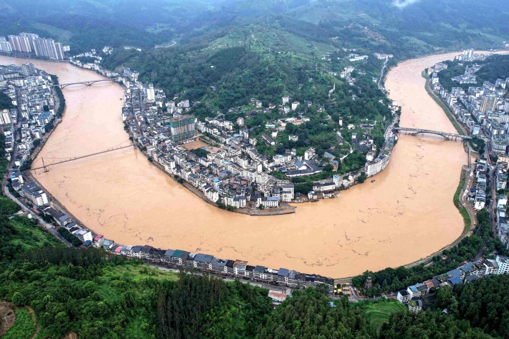 Six dead as floodwaters from upstream swamp China's Guangxi, cyclone looms