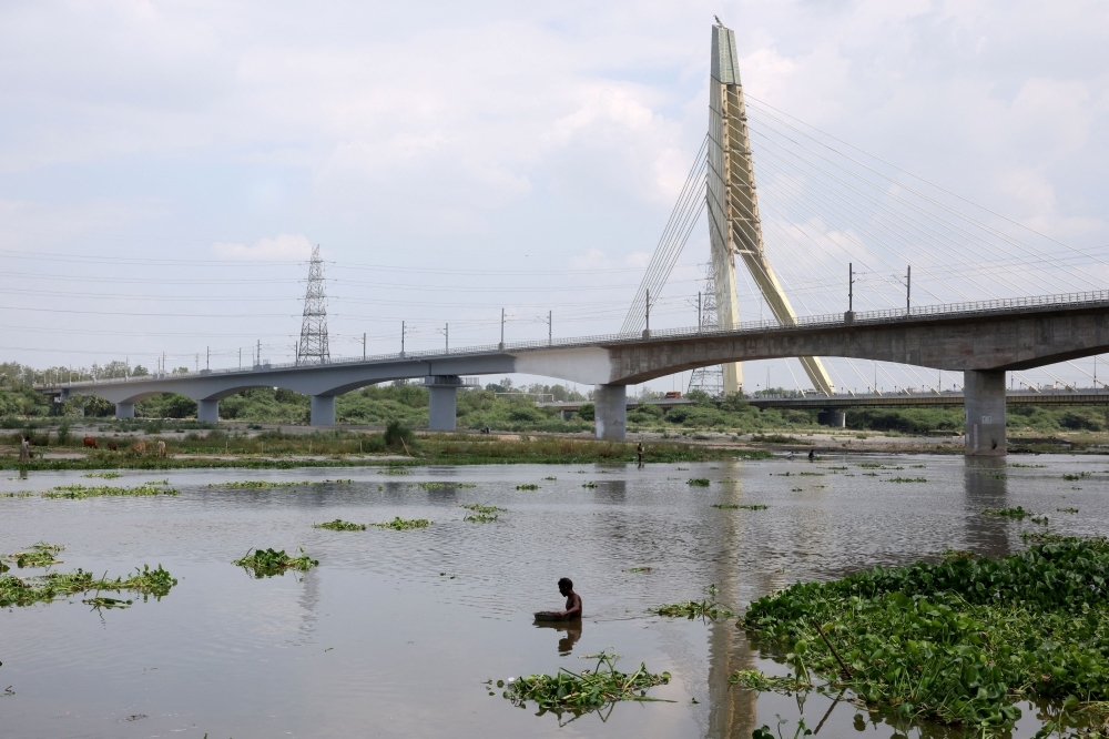 Risking it all in the holy river: India's scrap divers search for fortune beneath filth