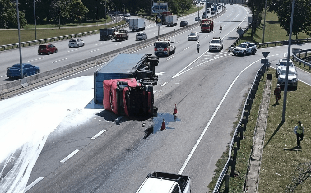 Chemical spill on Kesas Highway after container lorry flips