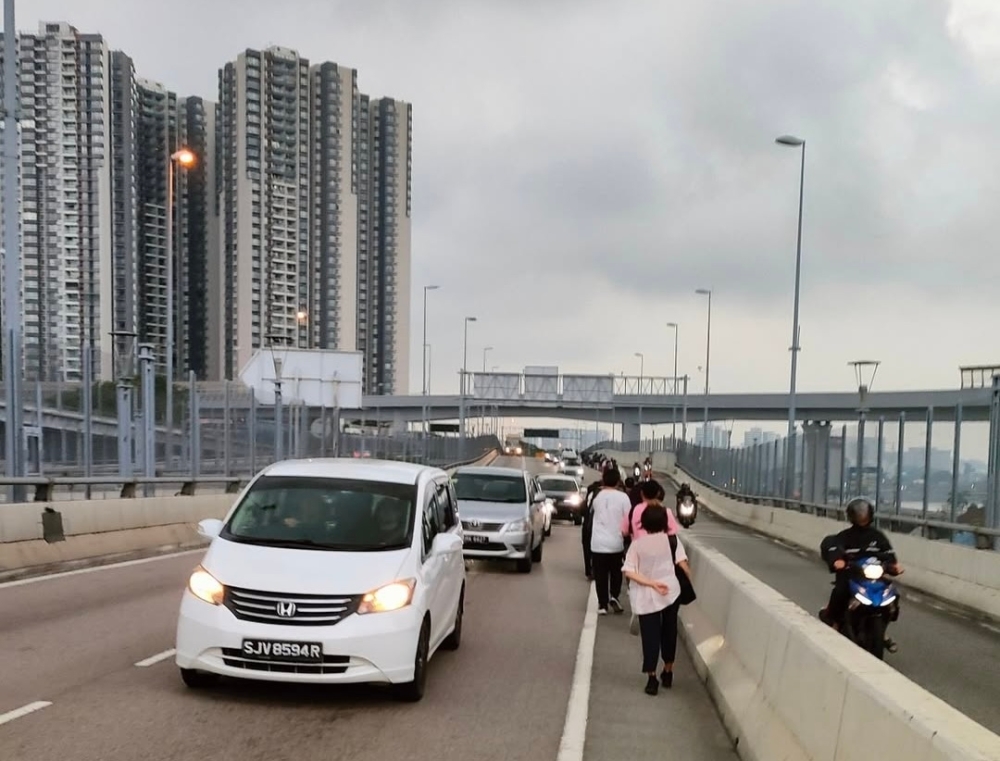 With bus drivers on strike, Malaysians working in Singapore walk across border to work
