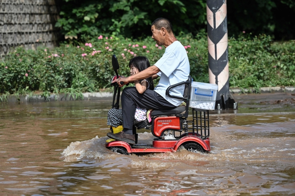 China villagers clean up after ‘once in a hundred years' flood