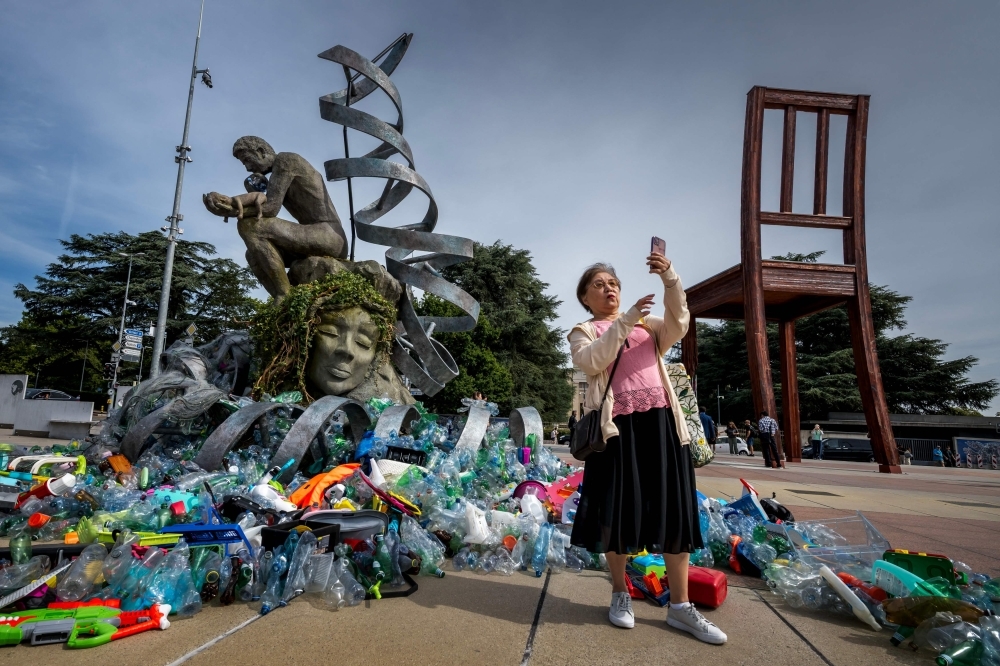 A ‘Thinker' drowns in plastic as protest sculpture highlights pollution during UN treaty talks
