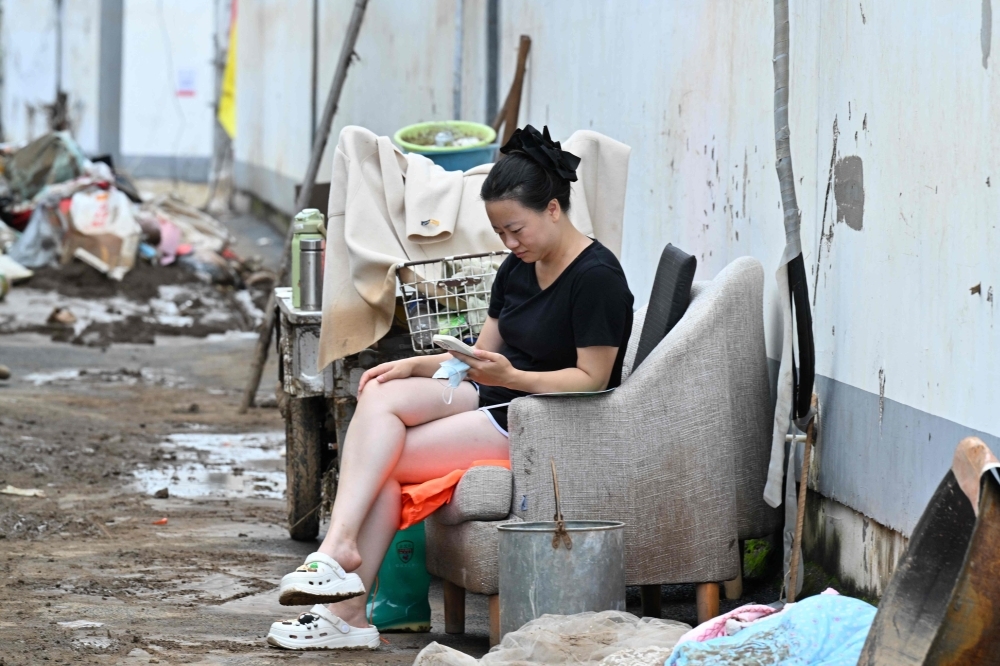 Beijing lifts red rain alert but warns of floods, landslides after evacuating over 82,000