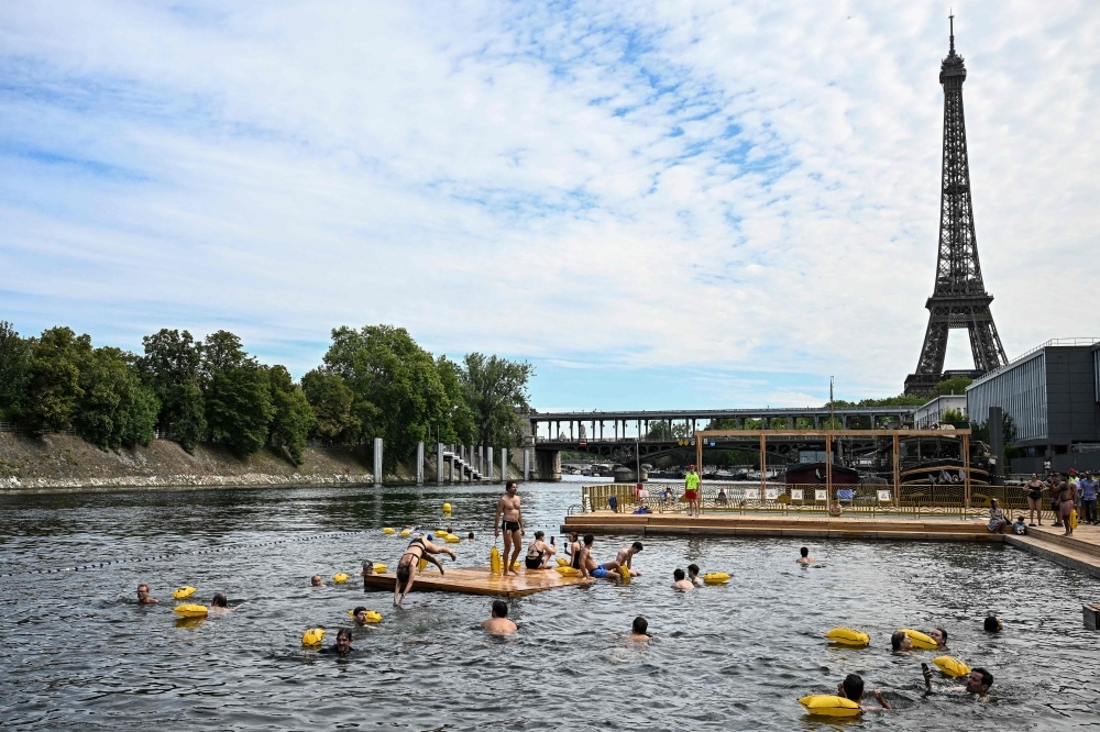 Seine sees record turnout as thousands of Parisians brave rain to swim in cleaned-up river