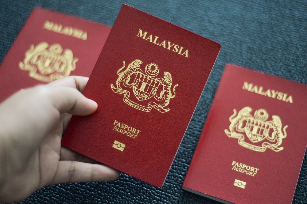 Housewife charged with holding 205 Malaysian passports, fake and stolen MyKad in Puchong raid