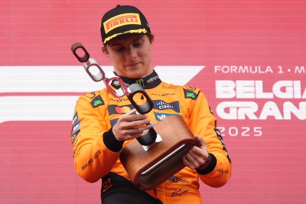 Piastri stretches lead after passing Norris in delayed Belgian GP