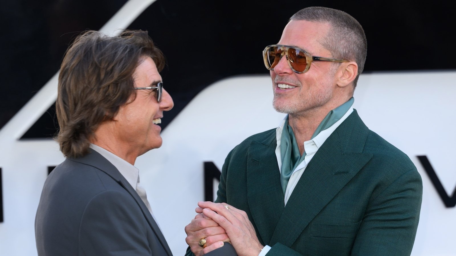 Brad Pitt embraces Tom Cruise at F1: The Movie premiere