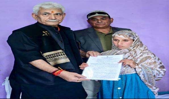 LG Sinha hands over job letter to braveheart Adil's wife in Anantnag