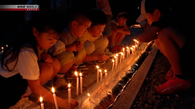 Worshipers pray for ancestors with 100,000 candles at Koyasan, western Japan